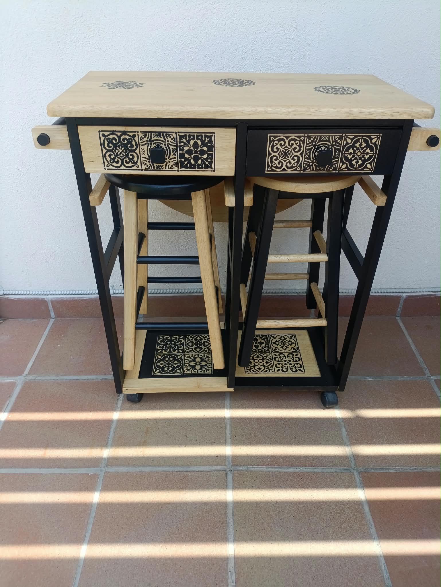 Mesa y taburetes restaurados con motivos decorativos